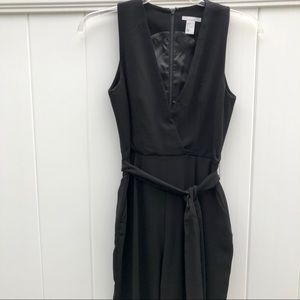 Black low cut jumper with tie at waist
